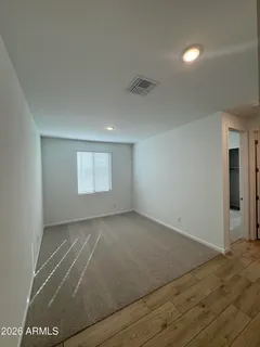 an empty room with a empty space and windows