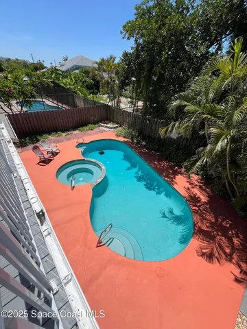 a view of a swimming pool with a yard