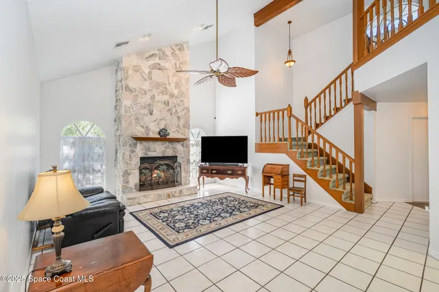 a living room with wooden floor and a fireplace