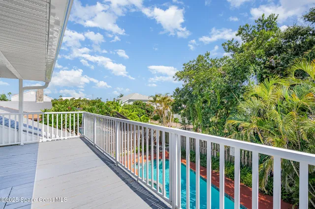 a view of balcony with wooden floor and outdoor seating