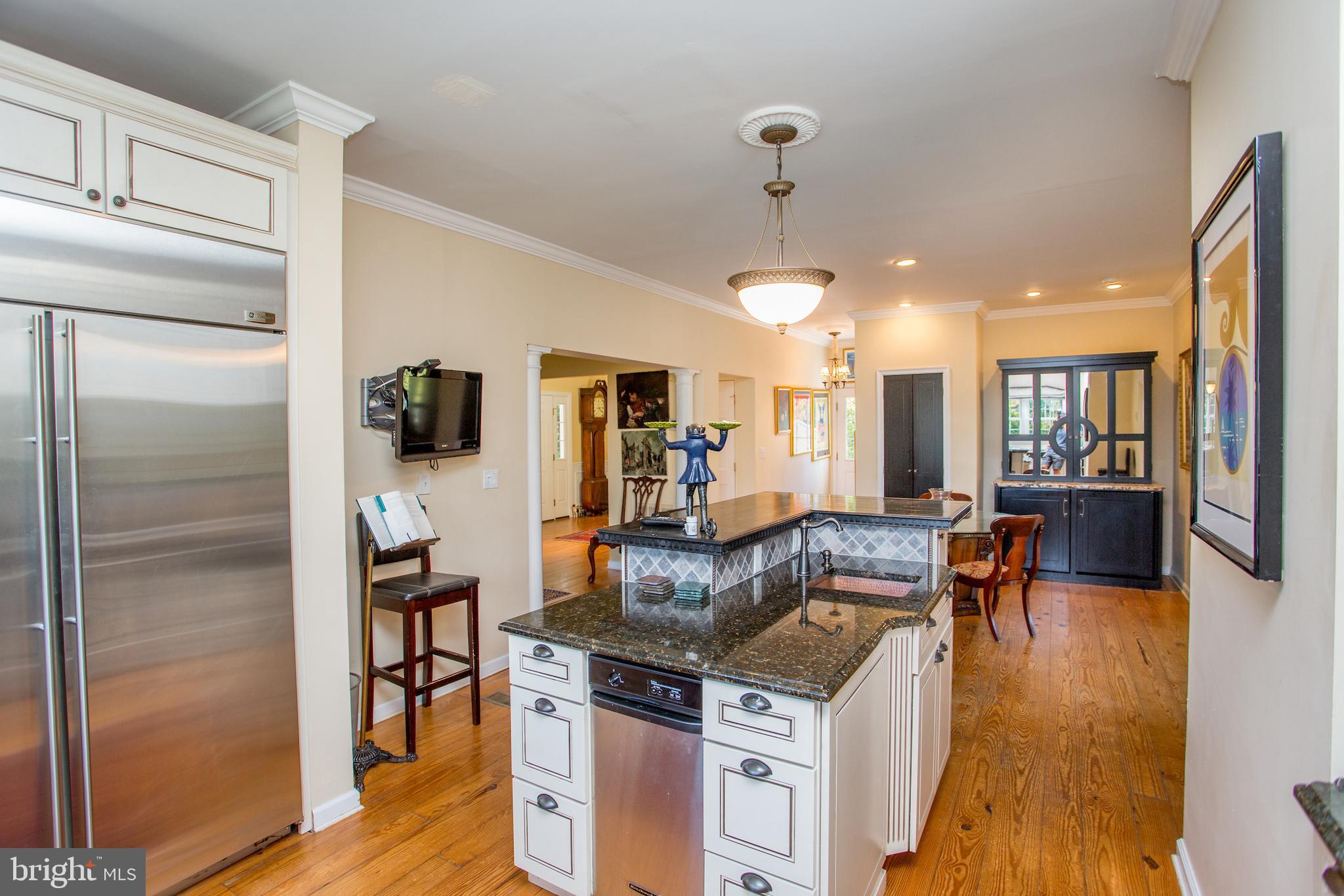3605 Windy Bush Road New Hope, PA 18938 - Photo 12 of 55 a kitchen with stainless steel appliances granite countertop a refrigerator a stove and a dining table with wooden floor