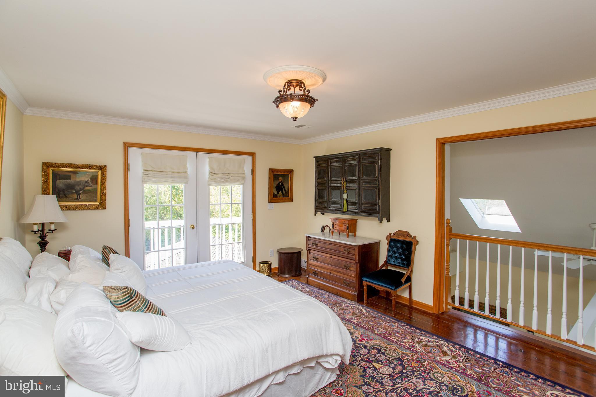 3605 Windy Bush Road New Hope, PA 18938 - Photo 26 of 55 a bedroom with a bed and a chandelier