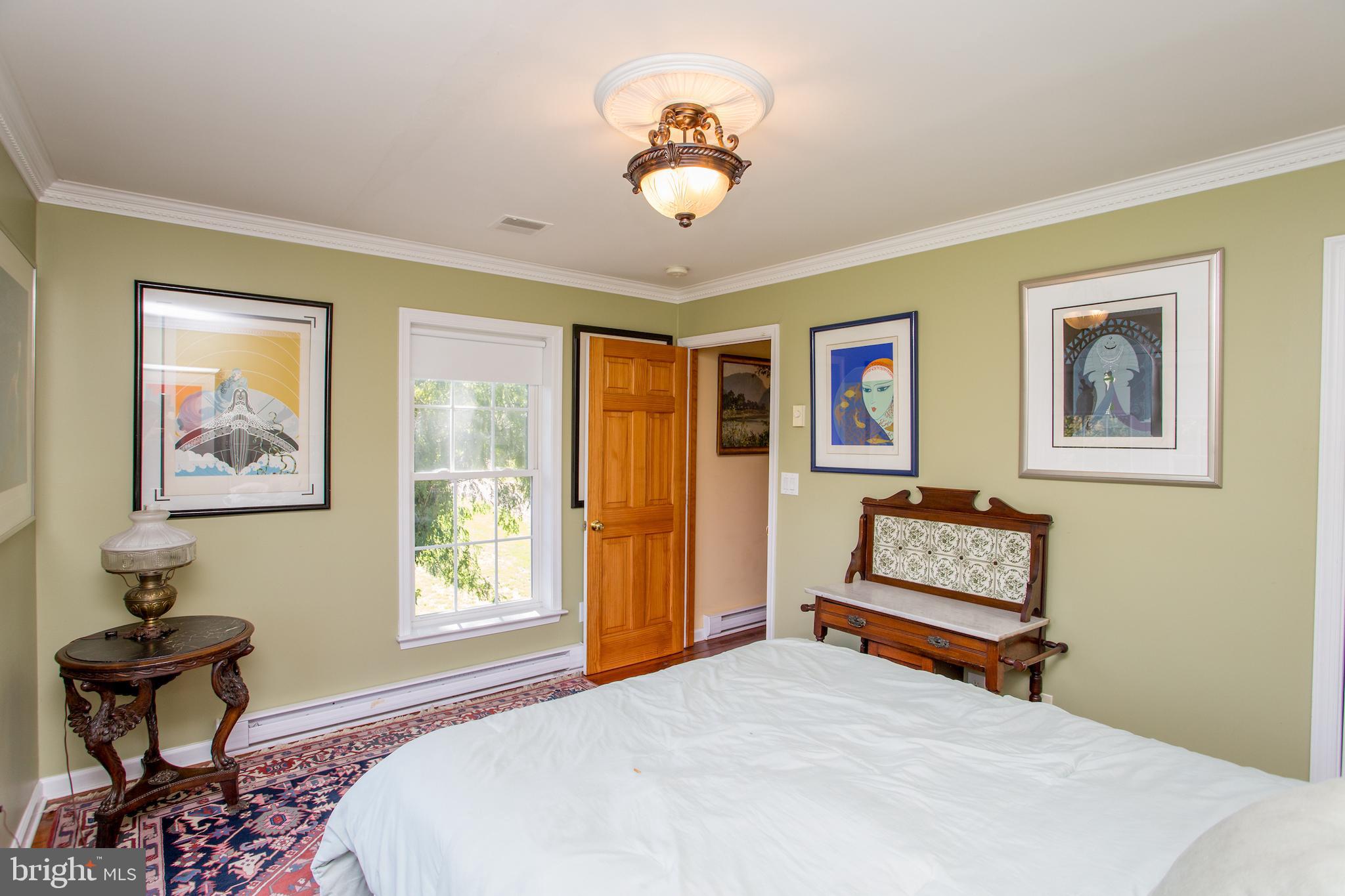 3605 Windy Bush Road New Hope, PA 18938 - Photo 31 of 55 a bedroom with a bed and a chandelier