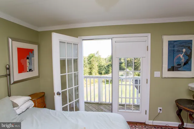 a view of a room with wooden floor and tub
