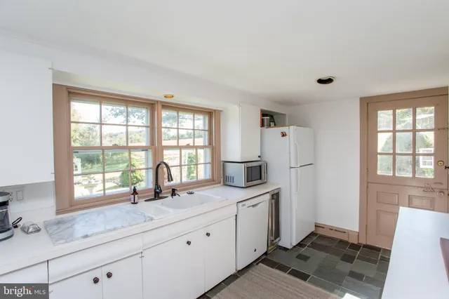 a view of a house with backyard porch and sitting area