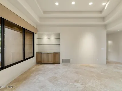 a view of a hallway with wooden floor and glass door