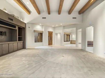 a kitchen with granite countertop a sink and white cabinets
