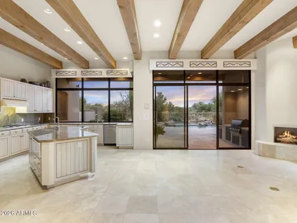 a kitchen with stainless steel appliances granite countertop a sink and a large window