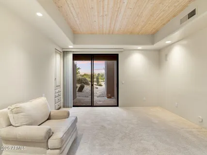 a view of an empty room with a fireplace and a window