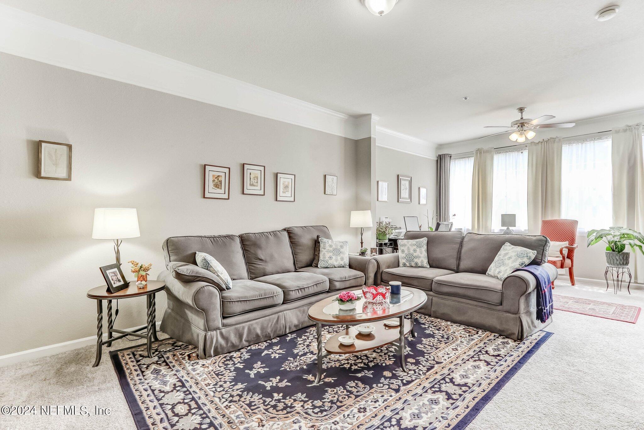 a living room with furniture and a rug