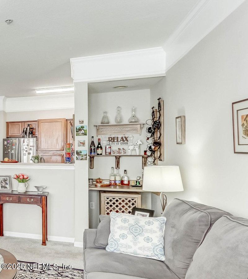 8550 Touchton Road, Unit 1423 Jacksonville, FL 32216 - Photo 11 of 36 a living room with furniture and painting on the wall