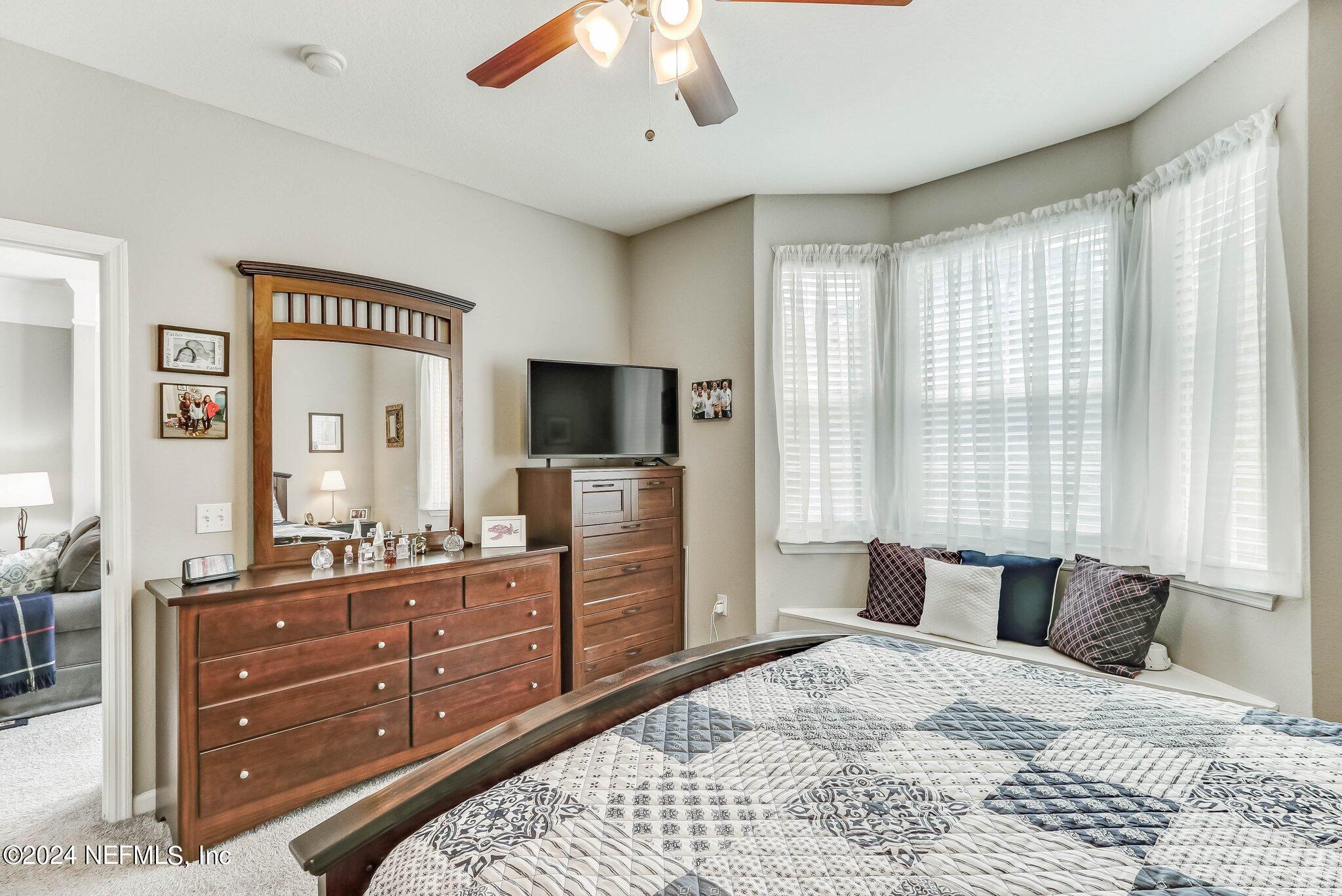 8550 Touchton Road, Unit 1423 Jacksonville, FL 32216 - Photo 14 of 36 a bedroom with a bed and a flat screen tv