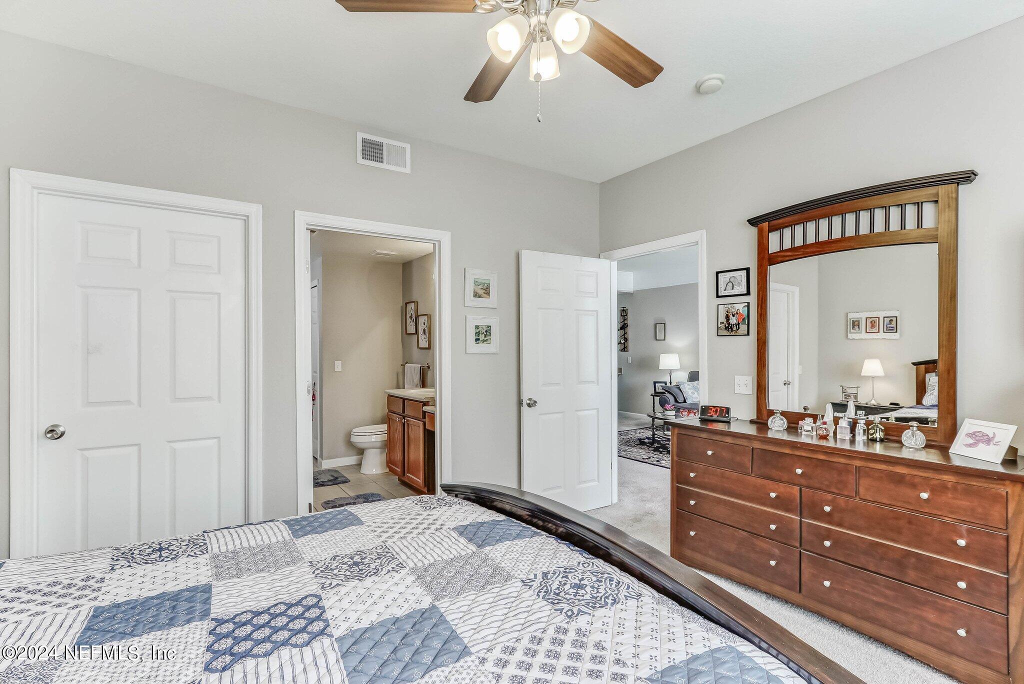 8550 Touchton Road, Unit 1423 Jacksonville, FL 32216 - Photo 15 of 36 a spacious bathroom with a granite countertop sink and a mirror