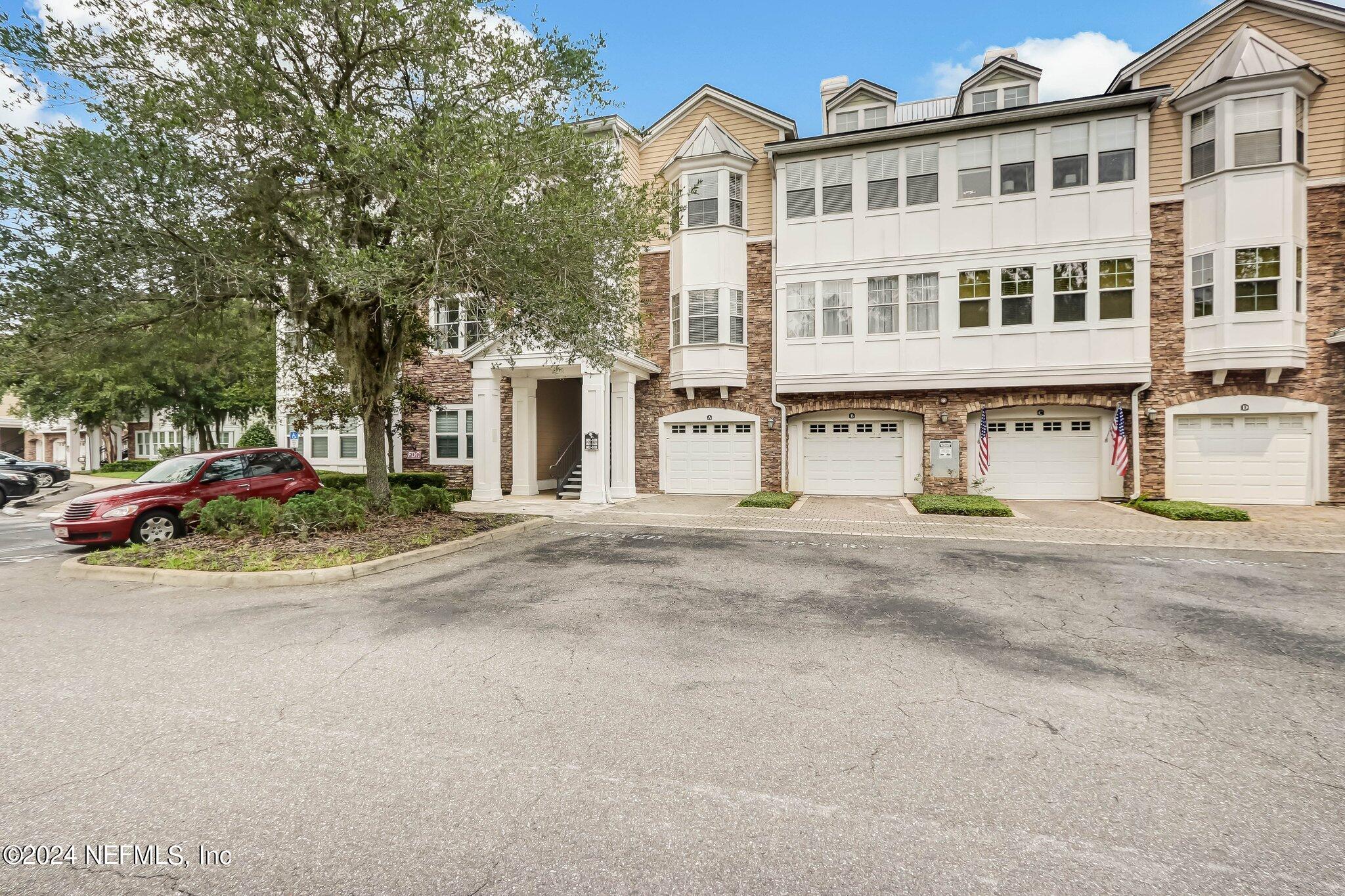 8550 Touchton Road, Unit 1423 Jacksonville, FL 32216 - Photo 20 of 36 a view of a white house with a yard and parking space