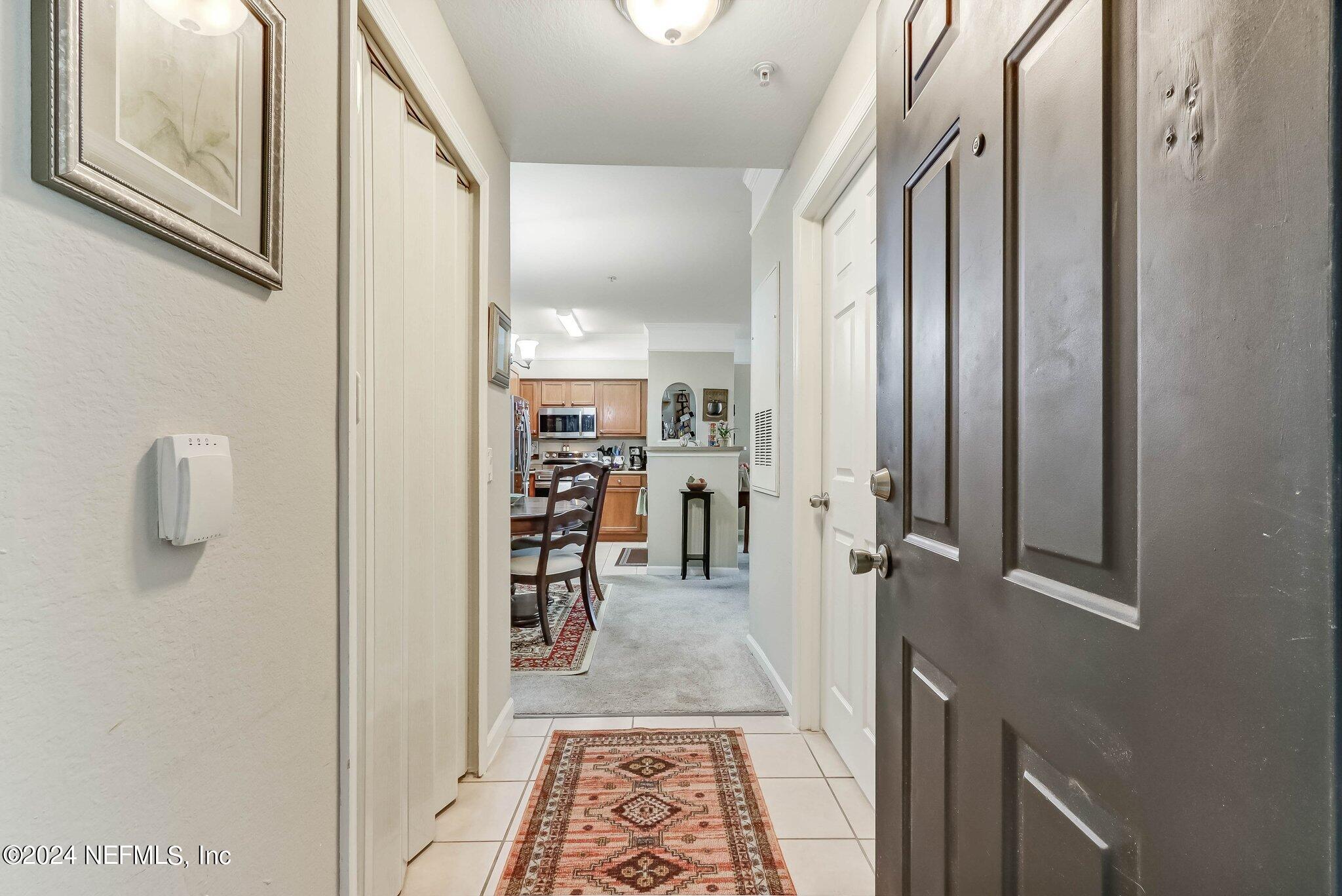 8550 Touchton Road, Unit 1423 Jacksonville, FL 32216 - Photo 3 of 36 a view of a hallway with wooden floor and staircase