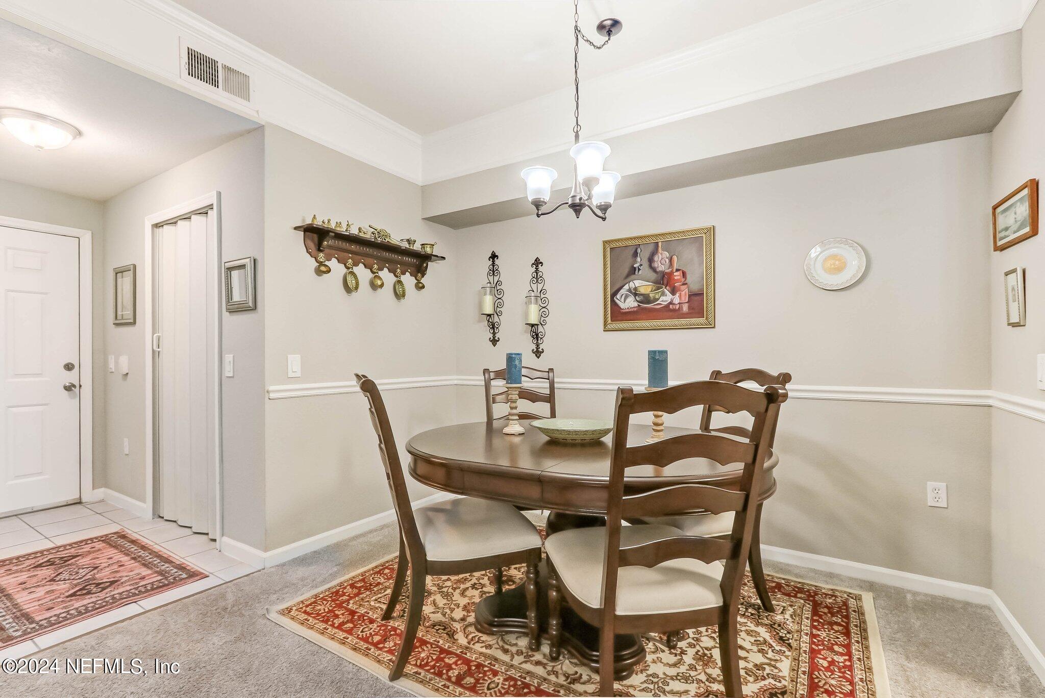 8550 Touchton Road, Unit 1423 Jacksonville, FL 32216 - Photo 6 of 36 a view of a dining room with furniture