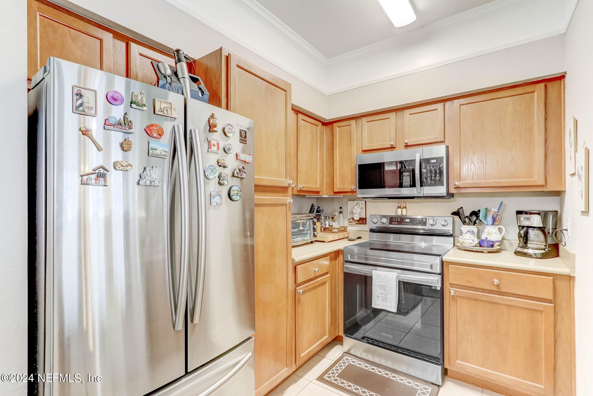 8550 Touchton Road, Unit 1423 Jacksonville, FL 32216 - Photo 7 of 36 a kitchen with stainless steel appliances a refrigerator sink and microwave