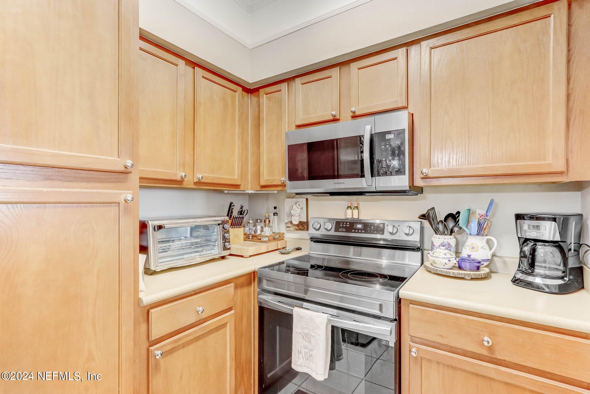 8550 Touchton Road, Unit 1423 Jacksonville, FL 32216 - Photo 8 of 36 a kitchen with stainless steel appliances granite countertop a sink a stove and cabinets