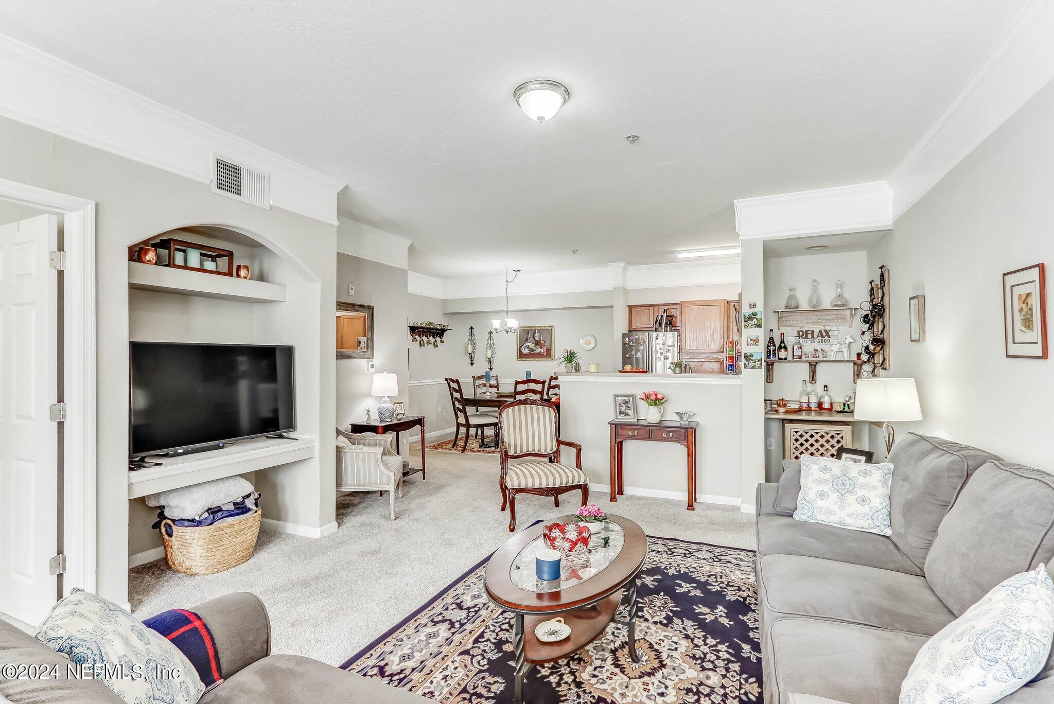 8550 Touchton Road, Unit 1423 Jacksonville, FL 32216 - Photo 10 of 36 a living room with furniture and a flat screen tv