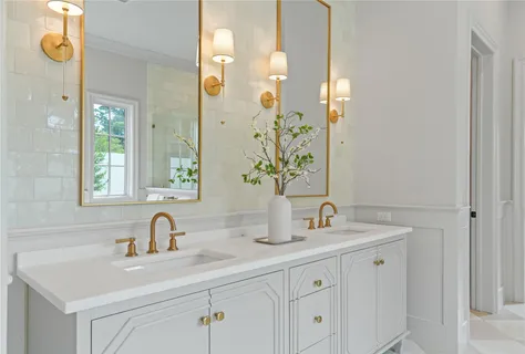 a white bath tub sitting in a bathroom next to a window