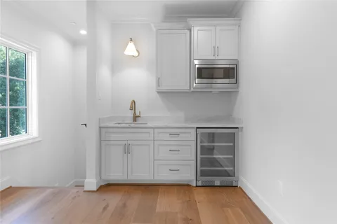 a bathroom with a double vanity sink a large mirror and a window