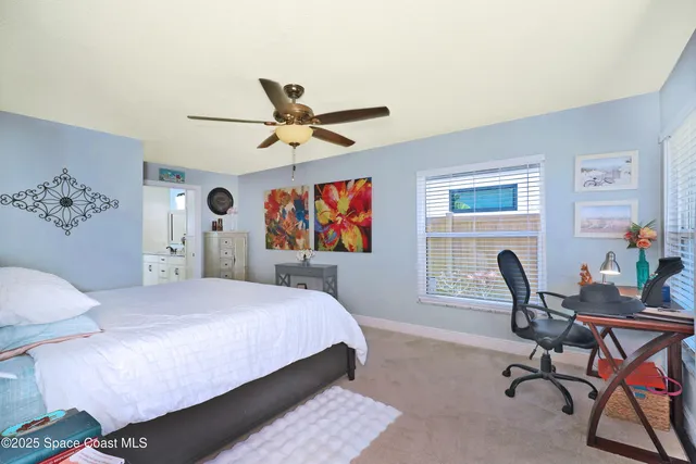a view of a swimming pool with a lawn chairs under an umbrella