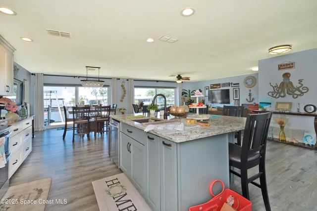 a kitchen with counter space dining table and chairs
