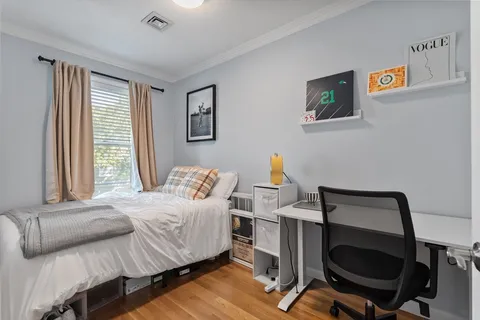 a bedroom with a bed and a desk