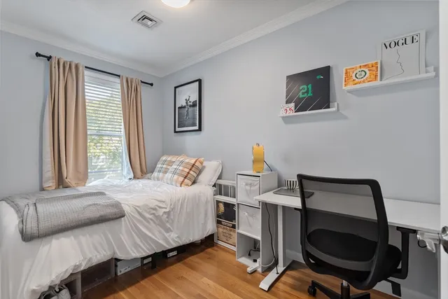 a bedroom with a bed and a desk