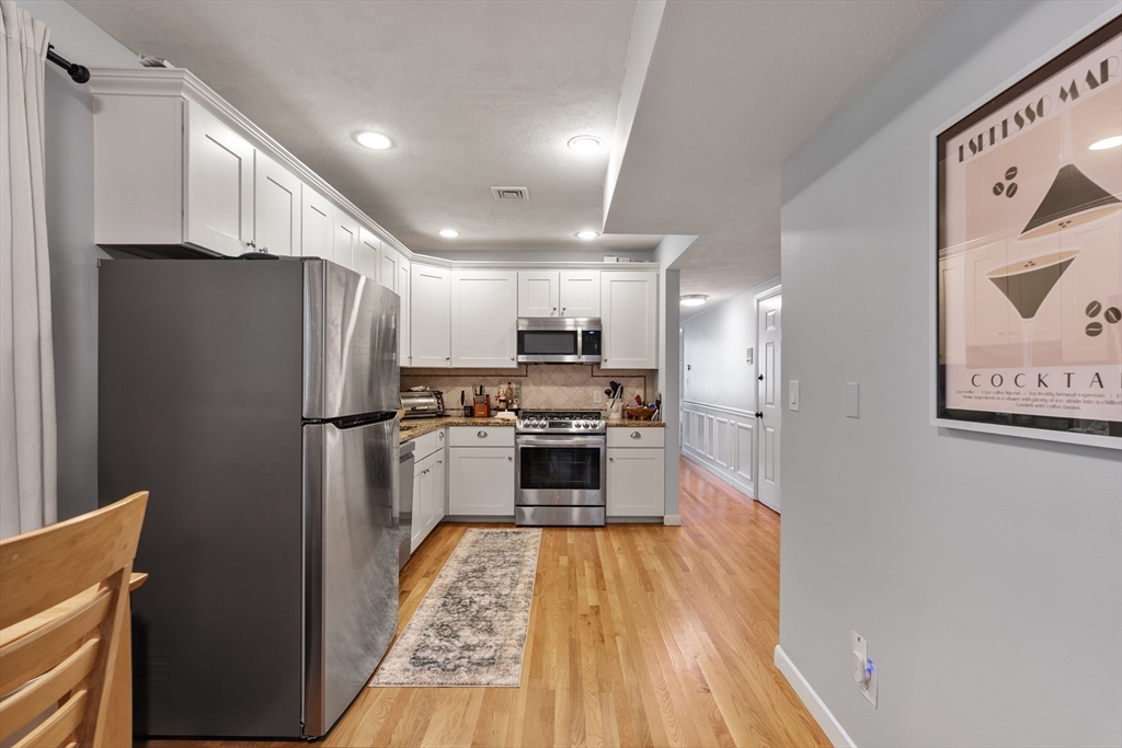 843 East 2nd Street, Unit 2 Boston, MA 02127 - Photo 6 of 12 a kitchen with stainless steel appliances a refrigerator and a stove top oven