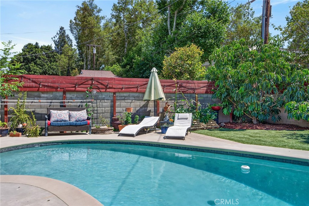 4194 Euclid Court Riverside, CA 92504 - Photo 22 of 29 Serene backyard with fruit trees and garden beds -- and the inviting pool creates the perfect setting for staycations and weekend gatherings!