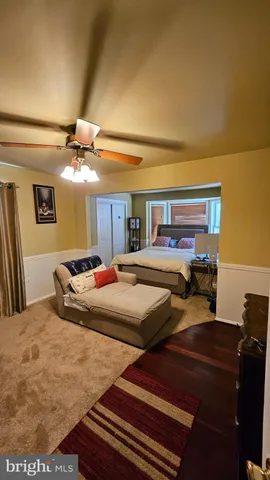 a bedroom with a bed and a ceiling fan