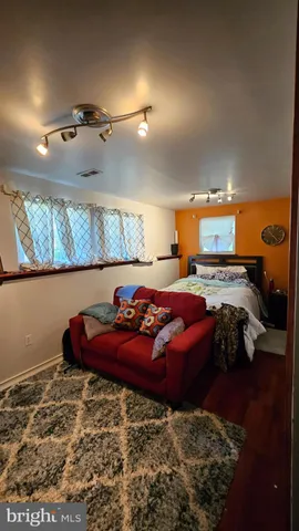 a view of a swimming pool with lawn chairs under an umbrella