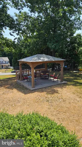a backyard of a house with yard and outdoor seating