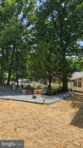 a view of a house with barbeque and wooden floor