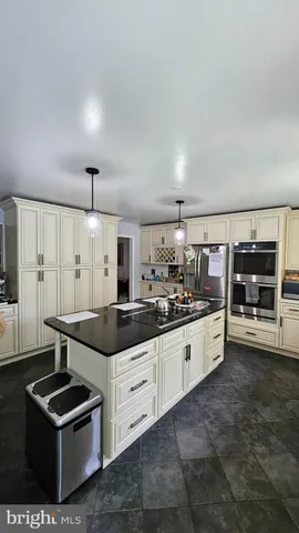 a kitchen with granite countertop a sink and cabinets