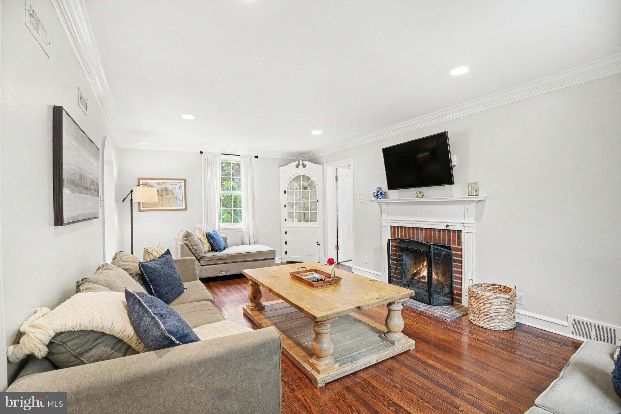 235 Hopkins Road Haddonfield, NJ 08033 - Photo 17 of 47 a living room with furniture a fireplace and a flat screen tv