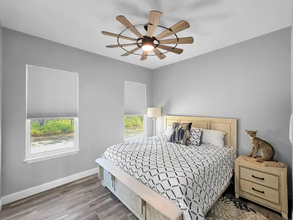 a bedroom with a large bed and a chandelier