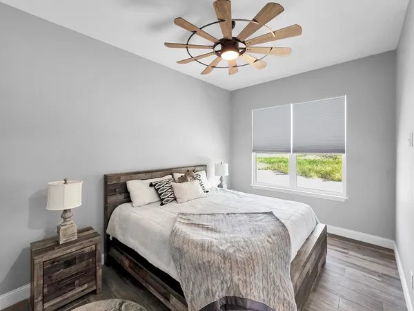 a bedroom with a bed and a chandelier