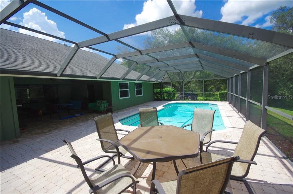 5349 Old Ranch Road Sarasota, FL 34241 - Photo 8 of 25 POOL DECK HAS PAVERS AND A COVERED SEATING AREA