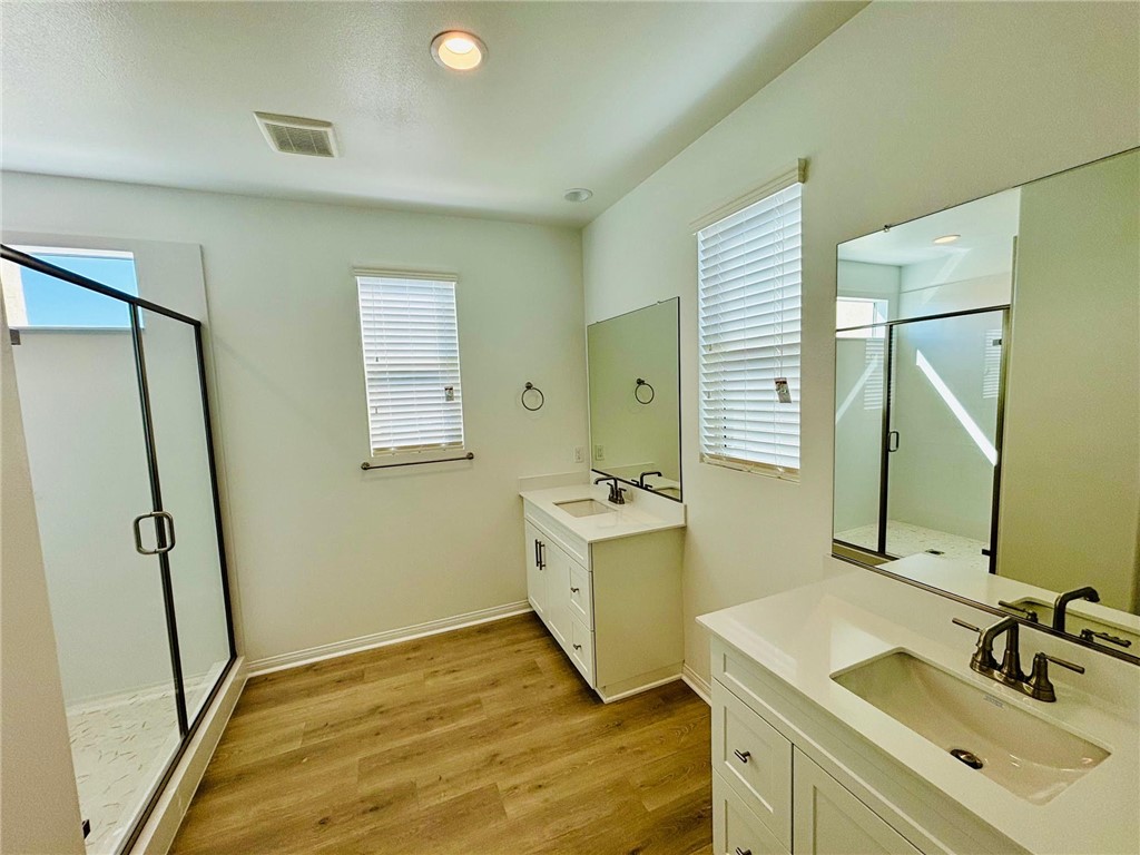 27366 Hyland Newhall, CA 91321 - Photo 17 of 31 a bathroom with a sink a mirror and a shower