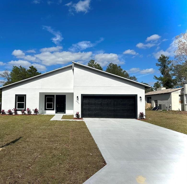 a front view of a house with yard and garage