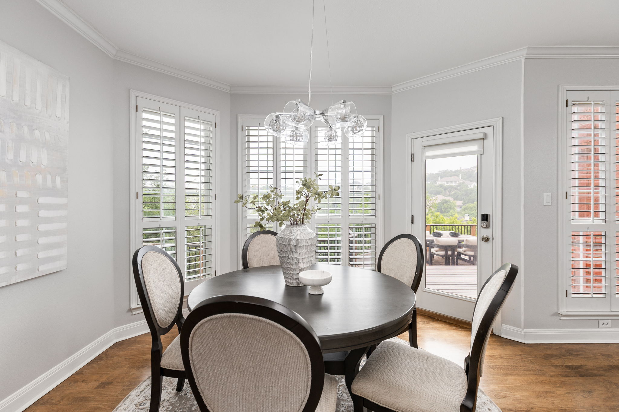 2807 Round Table Road Austin, TX 78746 - Photo 10 of 40 Dining area featuring a contemporary chandelier, wood-finish flooring, and crown molding