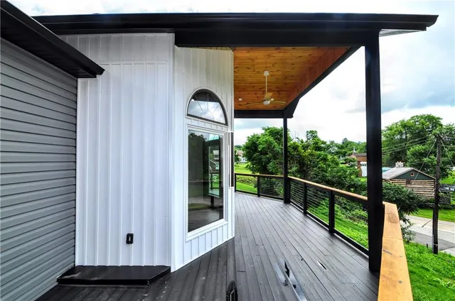 a view of a balcony with wooden floor