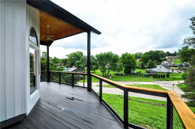 a view of balcony with wooden floor and fence