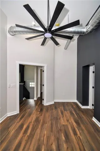 a view of a hallway with wooden floor and entryway