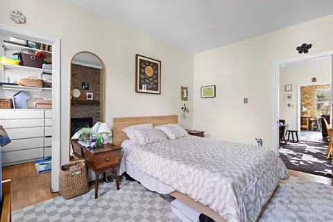 a bedroom with a bed and a book shelf