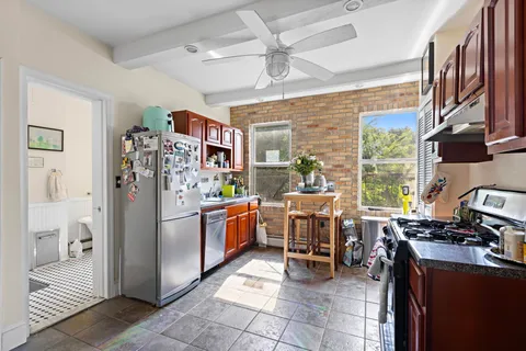 a kitchen with stainless steel appliances granite countertop a refrigerator and a stove top oven
