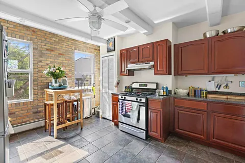 a kitchen with stainless steel appliances granite countertop a stove a sink dishwasher and a refrigerator