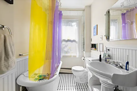 a bathroom with a sink a toilet and a bathtub